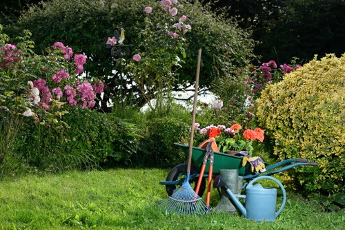Gardener preparing tools for lawn mowing in Harrow front garden